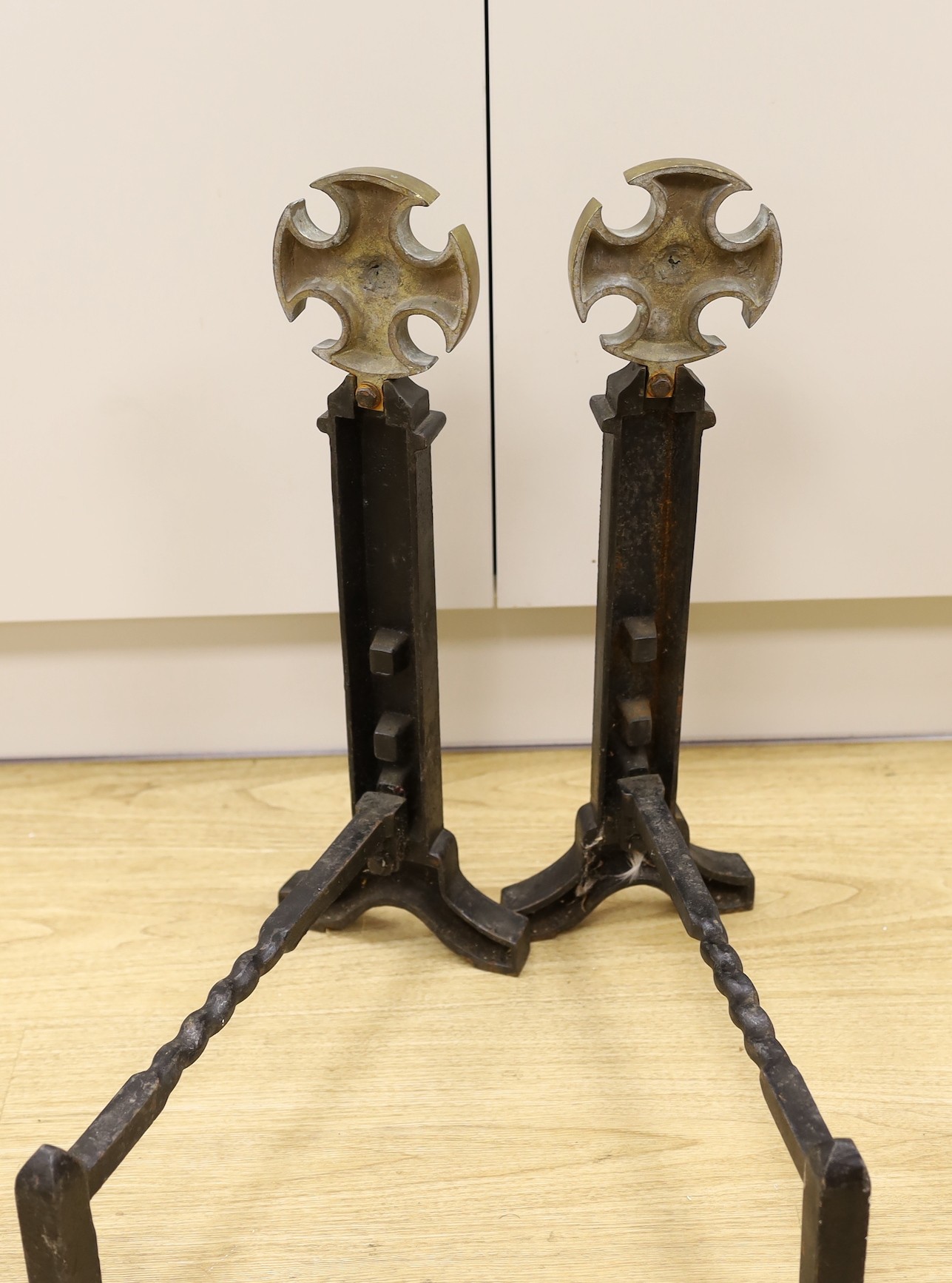 A pair of Victorian cast iron and brass fire dogs, 54cm tall